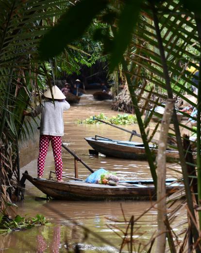 Lady on boat in Mekong Delta