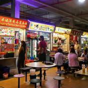 People queuing at food stalls in Singapore Hawker Centre