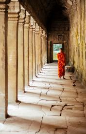 Monk walking under temple arches